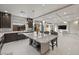 A modern kitchen features a large island with seating and an open layout leading into the living area at 6618 Tangled Vines Ave, Las Vegas, NV 89139