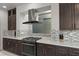 Modern kitchen with stainless steel appliances, quartz countertops, and stylish backsplash at 6618 Tangled Vines Ave, Las Vegas, NV 89139