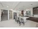 Modern kitchen featuring a large island, breakfast bar, and stainless steel appliances at 6618 Tangled Vines Ave, Las Vegas, NV 89139