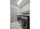 Functional laundry room featuring modern washer and dryer units and ample counter space at 6618 Tangled Vines Ave, Las Vegas, NV 89139