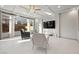 Cozy living room with modern furnishings, tile flooring, and plenty of natural light at 6618 Tangled Vines Ave, Las Vegas, NV 89139