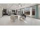 Bright living room features sleek tile flooring, large windows, and flows seamlessly into the kitchen at 6618 Tangled Vines Ave, Las Vegas, NV 89139