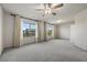 Open living space with gray carpet, windows and lots of natural light at 6618 Tangled Vines Ave, Las Vegas, NV 89139