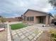 Backyard featuring synthetic grass, pavers, and an outdoor living space at 6946 Motley Rd, Las Vegas, NV 89178