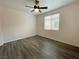 Bright bedroom features hardwood floors and a modern ceiling fan at 6946 Motley Rd, Las Vegas, NV 89178