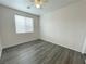 Bedroom features hardwood floors, ceiling fan, and bright window at 6946 Motley Rd, Las Vegas, NV 89178