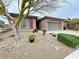 Charming single-story home with a low-maintenance desert landscaped front yard and a two-car garage at 6946 Motley Rd, Las Vegas, NV 89178