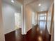 Hallway featuring wood floors, white walls, and multiple doorways leading to other rooms at 6946 Motley Rd, Las Vegas, NV 89178