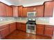 Kitchen with stainless steel appliances, granite countertops, and dark wood cabinets at 6946 Motley Rd, Las Vegas, NV 89178