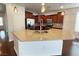 Kitchen island with granite countertops, a stainless steel sink, and ample cabinet space at 6946 Motley Rd, Las Vegas, NV 89178