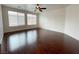 Spacious living room featuring hardwood floors and a ceiling fan for added comfort at 6946 Motley Rd, Las Vegas, NV 89178