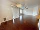 Open living space with wood floors, large windows, and a modern chandelier near the kitchen at 6946 Motley Rd, Las Vegas, NV 89178