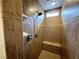 Tiled shower with built in bench and shower head with a window for natural light at 6946 Motley Rd, Las Vegas, NV 89178