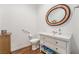 Well-lit bathroom featuring vanity with drawers, commode and oval mirror at 715 Orange Plume Walk, Henderson, NV 89011