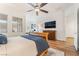 Bedroom with hardwood floors, dresser and ceiling fan at 715 Orange Plume Walk, Henderson, NV 89011