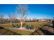 Common area with chairs placed on a brick pad, near grass, trees, and a fenced perimeter at 715 Orange Plume Walk, Henderson, NV 89011
