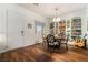 Dining area featuring a round table, chairs, a bookcase, wood floors, and an entry door at 715 Orange Plume Walk, Henderson, NV 89011