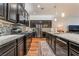 Modern kitchen featuring granite countertops, a tile backsplash, and stainless steel appliances at 715 Orange Plume Walk, Henderson, NV 89011