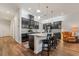 Stylish kitchen featuring a kitchen island with bar stools, dark cabinetry, and stainless steel appliances at 715 Orange Plume Walk, Henderson, NV 89011