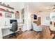 Bright office features wood floors, white built-ins, floating shelves, decor, a modern desk and accent chair at 715 Orange Plume Walk, Henderson, NV 89011