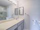 Bright bathroom with modern fixtures, vanity, and large mirror at 725 N Royal Crest Cir # 228, Las Vegas, NV 89169