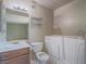 Well-lit bathroom features vanity, toilet, and walk-in bathtub at 725 N Royal Crest Cir # 228, Las Vegas, NV 89169