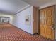 Condo hallway with patterned carpet leading to doors, lighting, and a fire hose cabinet at 725 N Royal Crest Cir # 228, Las Vegas, NV 89169