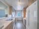 Modern kitchen with stainless-steel appliances and an adjacent laundry area at 725 N Royal Crest Cir # 228, Las Vegas, NV 89169