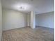 Modern minimalist living room featuring updated floors and a large column in the center at 725 N Royal Crest Cir # 228, Las Vegas, NV 89169