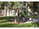 Outdoor patio with a built-in grill, dining area, and lush landscaping at 725 N Royal Crest Cir # 228, Las Vegas, NV 89169