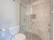 Walk-in shower with marble tiling and a built-in seat, combining luxury with accessibility at 725 N Royal Crest Cir # 228, Las Vegas, NV 89169