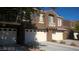 Well maintained townhome exterior with two floors, private garage, and balcony area at 7290 Sheared Cliff Ln # 102, Las Vegas, NV 89149