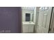 Bright bathroom featuring a single sink vanity, neutral tile flooring, and a framed mirror at 75 N Valle Verde Dr # 2121, Henderson, NV 89074