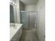 Bathroom featuring tiled floors, a vanity with a sink, and a bathtub with sliding glass doors at 75 N Valle Verde Dr # 2121, Henderson, NV 89074