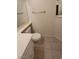Neutral-toned bathroom featuring a toilet, vanity with sink, and mirror above a towel rack at 75 N Valle Verde Dr # 2121, Henderson, NV 89074