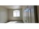 Neutral bedroom with vinyl floor, white window, and closet at 75 N Valle Verde Dr # 2121, Henderson, NV 89074