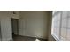 Bright bedroom features a neutral palette, wood-look flooring, and natural light from a window at 75 N Valle Verde Dr # 2121, Henderson, NV 89074