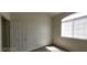 Neutral bedroom with vinyl floor featuring a window and white door at 75 N Valle Verde Dr # 2121, Henderson, NV 89074