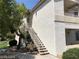 Condo exterior featuring stairs to the second floor and mature landscaping at 75 N Valle Verde Dr # 2121, Henderson, NV 89074
