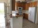Bright kitchen featuring tile floors, oak cabinets, white appliances and a breakfast bar at 75 N Valle Verde Dr # 2121, Henderson, NV 89074