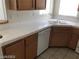 A cozy kitchen area with white countertops, stainless steel appliances, and wood cabinets at 75 N Valle Verde Dr # 2121, Henderson, NV 89074