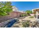 Spacious backyard featuring a brick wall, well-kept landscaping and plenty of space at 7515 Splashing Rock Dr, Las Vegas, NV 89131