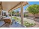Relaxing covered patio with views of the backyard and lush landscaping at 7515 Splashing Rock Dr, Las Vegas, NV 89131