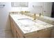Bathroom featuring a double sink vanity with granite countertop and modern gold faucets at 7515 Splashing Rock Dr, Las Vegas, NV 89131