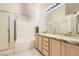 Bathroom features a shower, bathtub, dual sinks, granite countertops and neutral paint palette at 7515 Splashing Rock Dr, Las Vegas, NV 89131