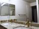 Bathroom with a granite countertop, double sink vanity, and modern bronze faucets at 7515 Splashing Rock Dr, Las Vegas, NV 89131