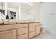 Bright bathroom featuring double sinks with stylish countertops and a large mirror at 7515 Splashing Rock Dr, Las Vegas, NV 89131
