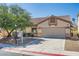 Inviting single-story home featuring a two-car garage and well-kept desert landscaping at 7515 Splashing Rock Dr, Las Vegas, NV 89131