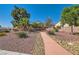 Welcoming front yard with a charming walkway and beautiful desert landscaping at 7515 Splashing Rock Dr, Las Vegas, NV 89131