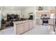 Open kitchen with an island, stainless steel appliances, and view of the living room at 7515 Splashing Rock Dr, Las Vegas, NV 89131